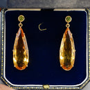 A pair of 9ct gold citrine and green tourmaline drop earrings in a blue velvet box