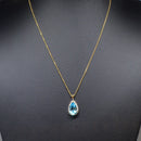 Swiss Blue Topaz and Diamond Halo Pendant With 9ct Yellow Gold Chain