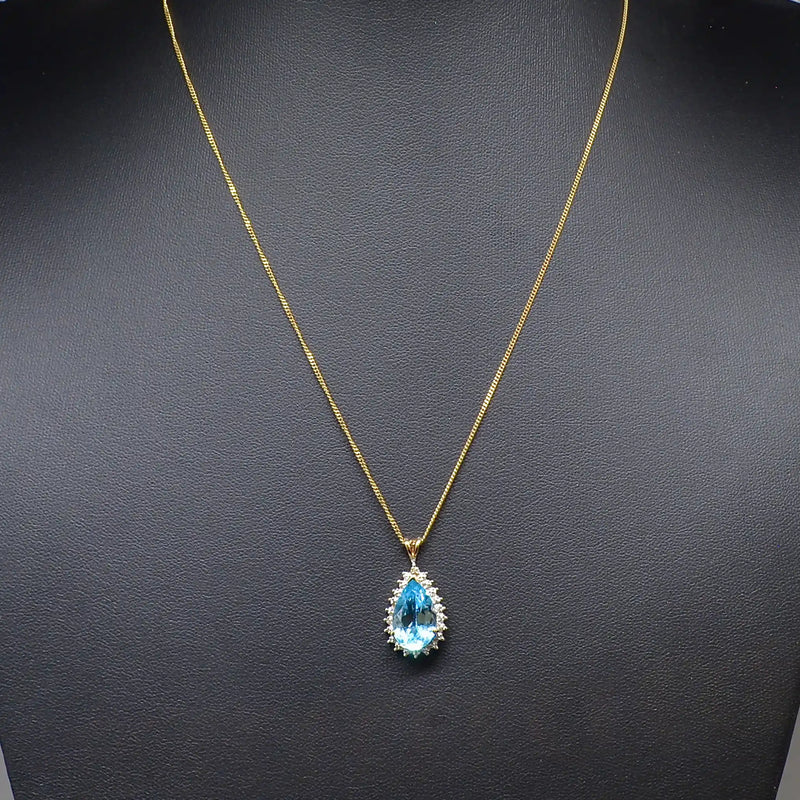 Swiss Blue Topaz and Diamond Halo Pendant With 9ct Yellow Gold Chain