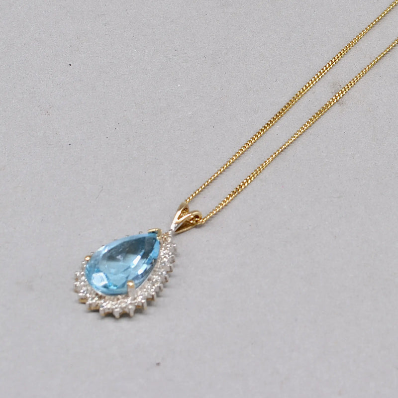 Swiss Blue Topaz and Diamond Halo Pendant With 9ct Yellow Gold Chain