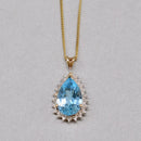Swiss Blue Topaz and Diamond Halo Pendant With 9ct Yellow Gold Chain