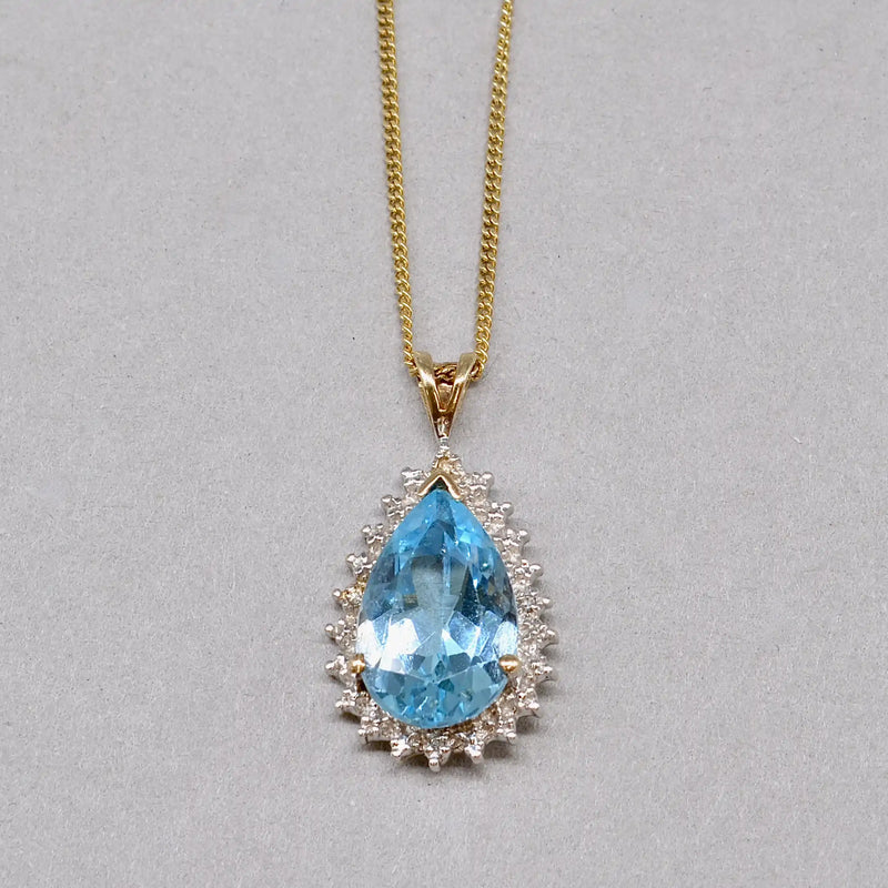 Swiss Blue Topaz and Diamond Halo Pendant With 9ct Yellow Gold Chain
