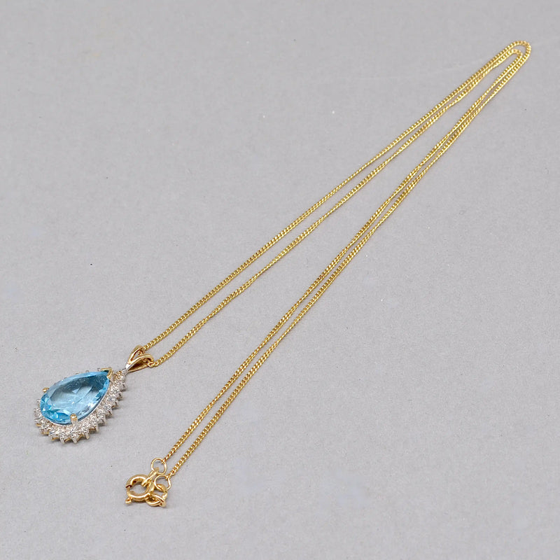 Swiss Blue Topaz and Diamond Halo Pendant With 9ct Yellow Gold Chain