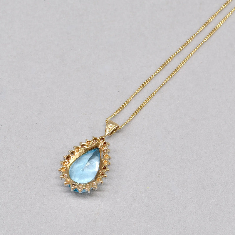 Swiss Blue Topaz and Diamond Halo Pendant With 9ct Yellow Gold Chain