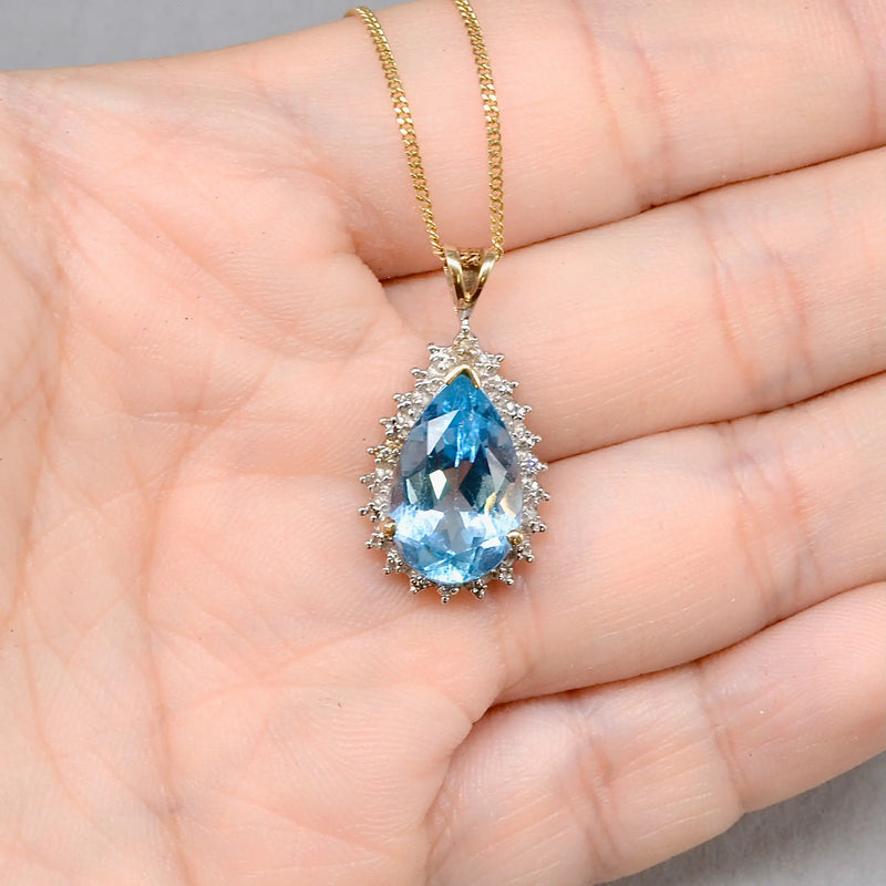 Swiss Blue Topaz and Diamond Halo Pendant With 9ct Yellow Gold Chain