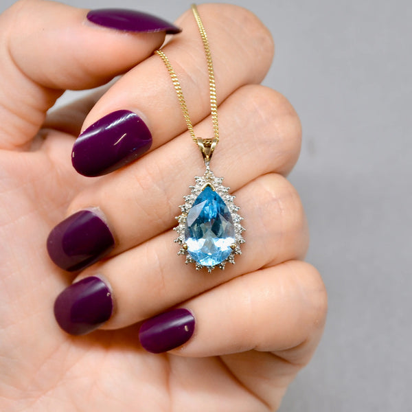 Swiss Blue Topaz and Diamond Halo Pendant With 9ct Yellow Gold Chain
