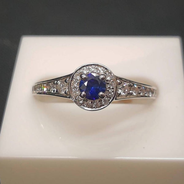 Blue Sapphire and diamond white gold halo ring