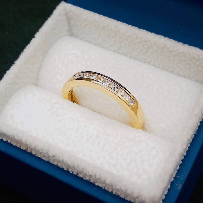 channel set half eternity diamond gold ring with princess cut diamonds in presentation box. wedding ring or anniversary gift