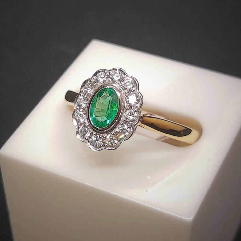 emerald and diamond cluster style engagement gold ring